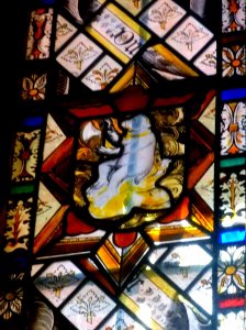 medieval glass ofbear holding an axe!